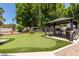 This backyard features a putting green, gazebo, and grill at 7512 W Tonto Dr, Glendale, AZ 85308
