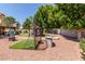 This backyard features a golf putting green, artificial turf, and a gazebo at 7512 W Tonto Dr, Glendale, AZ 85308
