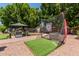 This backyard features artificial turf and a golf net at 7512 W Tonto Dr, Glendale, AZ 85308