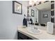 Bathroom with patterned mirror and white sink at 7512 W Tonto Dr, Glendale, AZ 85308