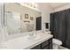 Bathroom with tile countertop, vanity, toilet, mirror and decorative framed art at 7512 W Tonto Dr, Glendale, AZ 85308