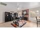 Versatile bonus room with fireplace, exercise equipment, and tile flooring at 7512 W Tonto Dr, Glendale, AZ 85308