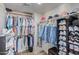 Spacious walk-in closet with clothing racks and shoe shelves at 7512 W Tonto Dr, Glendale, AZ 85308