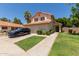 Charming two-story home with a well-manicured lawn and mature trees at 7512 W Tonto Dr, Glendale, AZ 85308