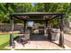 This gazebo features a dining table and chairs, and a grill at 7512 W Tonto Dr, Glendale, AZ 85308