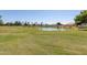 Scenic view of the well-manicured golf course with a tranquil pond, enhancing the community's appeal at 7512 W Tonto Dr, Glendale, AZ 85308