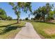 This golf course features a walking path and lush green grass at 7512 W Tonto Dr, Glendale, AZ 85308