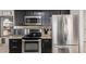 Updated kitchen with stainless steel appliances, granite countertops, and dark wood cabinets at 7512 W Tonto Dr, Glendale, AZ 85308
