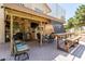 Outdoor patio features a grill, ceiling fan, tv, furniture, and stone flooring at 7512 W Tonto Dr, Glendale, AZ 85308