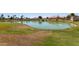 A scenic view of the community pond and lush green space provides a tranquil outdoor atmosphere at 7512 W Tonto Dr, Glendale, AZ 85308