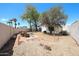 Spacious backyard with desert landscaping, a patio, and a privacy fence at 8521 W Mauna Loa Ln, Peoria, AZ 85381