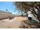 Fenced backyard featuring desert landscaping, palm trees, a patio, and an exterior view of the home at 8521 W Mauna Loa Ln, Peoria, AZ 85381