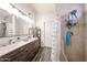 Bathroom with double sink vanity, stylish wood flooring, and shower at 8521 W Mauna Loa Ln, Peoria, AZ 85381