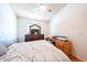 Cozy bedroom features a ceiling fan and a wooden floor at 8521 W Mauna Loa Ln, Peoria, AZ 85381