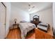 Cozy bedroom features a ceiling fan and a wooden floor at 8521 W Mauna Loa Ln, Peoria, AZ 85381