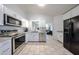 Spacious kitchen with stainless steel appliances, white cabinetry, and tile flooring at 8521 W Mauna Loa Ln, Peoria, AZ 85381