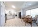 Eat-in kitchen features white cabinets, stainless steel appliances, tile floors, and a four-chair dining table at 8521 W Mauna Loa Ln, Peoria, AZ 85381