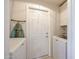 Convenient laundry room featuring a washing machine, dryer, and ironing board at 8521 W Mauna Loa Ln, Peoria, AZ 85381
