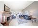 Open-concept living room with brick fireplace, plush sofa, and neutral decor at 8521 W Mauna Loa Ln, Peoria, AZ 85381