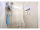 Close up of shower with tiled walls, tiled floors, niche, and sleek fixtures at 8521 W Mauna Loa Ln, Peoria, AZ 85381