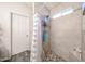 Shower with a window, tiled walls, tiled floors, and a sliding shower curtain at 8521 W Mauna Loa Ln, Peoria, AZ 85381