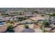 Aerial view of a suburban home featuring well-manicured lawns and a circular driveway on a tree lined street at 8767 W Villa Hermosa --, Peoria, AZ 85383