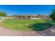 Expansive backyard with manicured lawn, gravel walkway, and a charming home exterior at 8767 W Villa Hermosa --, Peoria, AZ 85383