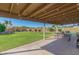 Inviting covered patio with grill, picnic table, and lounge area overlooking the spacious yard at 8767 W Villa Hermosa --, Peoria, AZ 85383