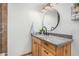 Bathroom vanity featuring wood cabinets, granite countertop, and stylish faucet and mirror at 8767 W Villa Hermosa --, Peoria, AZ 85383