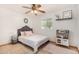 Cozy bedroom featuring stylish furnishings, a ceiling fan, and a window with plantation shutters at 8767 W Villa Hermosa --, Peoria, AZ 85383
