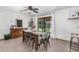 Dining room with a wooden table, chairs, and sliding glass doors to the backyard at 8767 W Villa Hermosa --, Peoria, AZ 85383