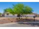Charming home featuring low-maintenance desert landscaping, mature tree, and a mailbox at 8767 W Villa Hermosa --, Peoria, AZ 85383