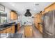 Kitchen with an island cooktop, stainless steel refrigerator, and light wood cabinets at 8767 W Villa Hermosa --, Peoria, AZ 85383
