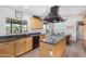 Bright kitchen with black appliances, an island cooktop, and light wood cabinetry at 8767 W Villa Hermosa --, Peoria, AZ 85383