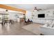 Open living area featuring tiled floors, beam accents, and access to the dining and kitchen areas at 8767 W Villa Hermosa --, Peoria, AZ 85383