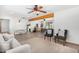 Open living area featuring tiled floors, beam accents, and access to the dining area at 8767 W Villa Hermosa --, Peoria, AZ 85383