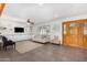 Living room with built-in shelving, plantation shutters, and tiled floors at 8767 W Villa Hermosa --, Peoria, AZ 85383