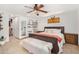 Main bedroom featuring a leather bed frame, tile floors, and a ceiling fan at 8767 W Villa Hermosa --, Peoria, AZ 85383