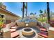 Outdoor grill area with a built-in barbecue, seating, and lush landscaping at 8787 E Mountain View Rd # 1029, Scottsdale, AZ 85258