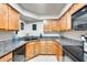 Functional kitchen features wood cabinetry, black granite countertops, and modern appliances at 8787 E Mountain View Rd # 1029, Scottsdale, AZ 85258