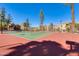 Well-maintained community tennis court with mature landscaping around residential buildings at 8787 E Mountain View Rd # 1029, Scottsdale, AZ 85258