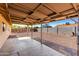 A large backyard featuring a covered patio, gravel landscaping, and block wall fencing at 9118 W Cameron Dr, Peoria, AZ 85345