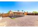 A gravel backyard with a covered patio on the back of a house at 9118 W Cameron Dr, Peoria, AZ 85345
