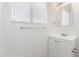This bright bathroom features a vanity, a sink with chrome fixtures, a mirror, and a window with blinds at 9118 W Cameron Dr, Peoria, AZ 85345