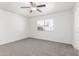 Bright bedroom with ceiling fan, window, and gray carpeting at 9118 W Cameron Dr, Peoria, AZ 85345
