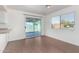 Cozy dining area featuring wood-look flooring, a window, and access to outdoor patio at 9118 W Cameron Dr, Peoria, AZ 85345