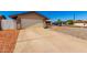 Wide driveway leading to a two-car garage, complemented by low-maintenance landscaping at 9118 W Cameron Dr, Peoria, AZ 85345