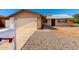 Attractive single-story home with a two-car garage and gravel landscaping for easy upkeep at 9118 W Cameron Dr, Peoria, AZ 85345