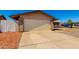 Spacious two-car garage with ample driveway space and xeriscaping at 9118 W Cameron Dr, Peoria, AZ 85345