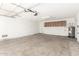 A spacious garage featuring concrete floors, storage cabinets, and a hot water heater at 9118 W Cameron Dr, Peoria, AZ 85345